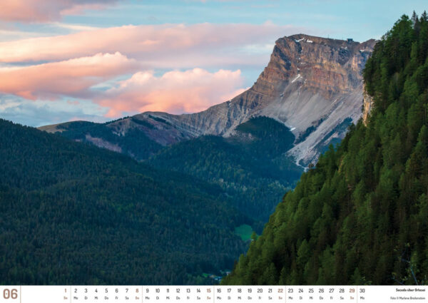 2025 Dolomiten Calendar, June. Photograph of the Seceda plateau over the town or Ortesei.