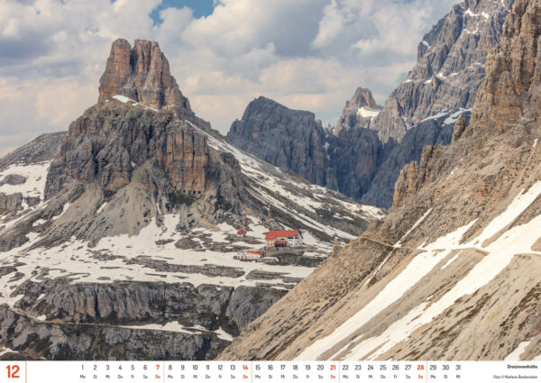 2025 Dolomiten Calendar, December. Photograph of the Dreizinnenhütte in a snowy mountain landscape.